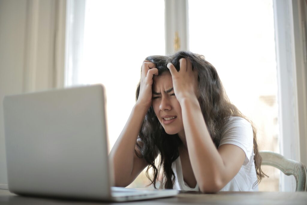 frustrated woman looking at laptop